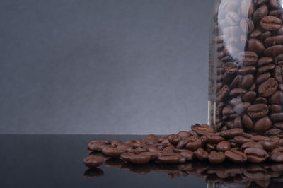 Stack of pebbles on table against wall