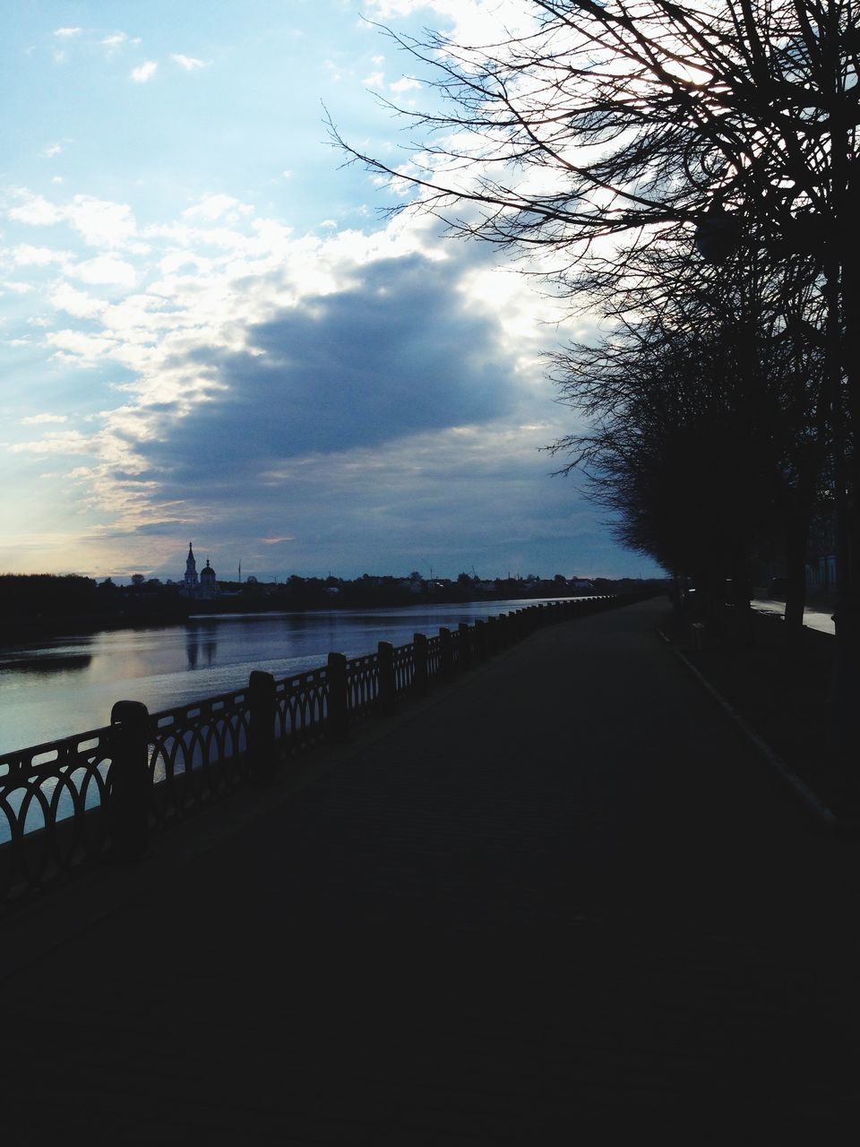 water, sky, tranquility, the way forward, tranquil scene, scenics, cloud - sky, tree, nature, silhouette, beauty in nature, lake, cloud, railing, river, pier, sea, diminishing perspective, outdoors, cloudy