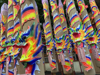 Low angle view of multi colored decorations hanging in row for sale