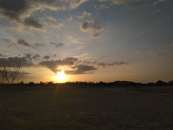 Scenic view of field against sky during sunset