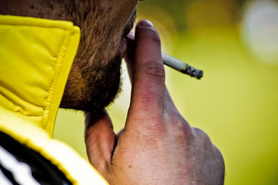 Cropped image of man smoking cigarette