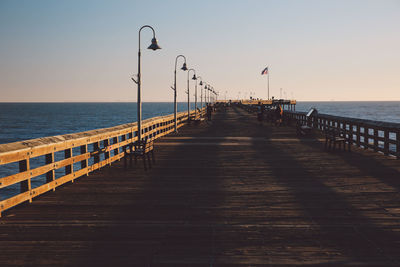 Pier over sea against clear sky