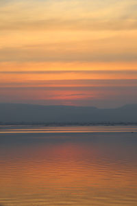 Scenic view of sea against romantic sky at sunset