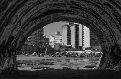 Buildings by sea against sky