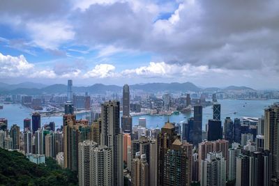 View of cityscape against cloudy sky