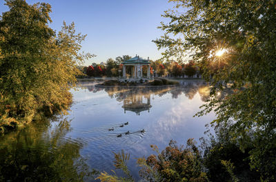 Scenic view of lake by buildings against sky