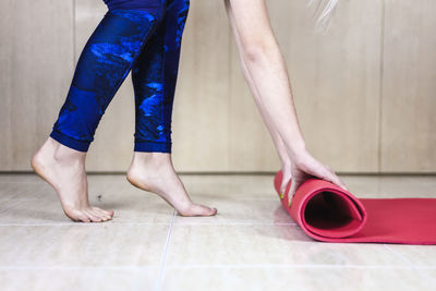 Low section of woman standing on hardwood floor