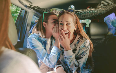 Female friends sitting in car