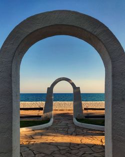 Scenic view of mediterranean sea against clear sky through  two arches