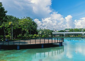 View of swimming pool against cloudy sky