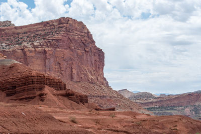 Capitol reef national park low angle landscape of pink, orange and purple barren stone hillside 