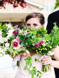 Woman holding bouquet of flowering plants