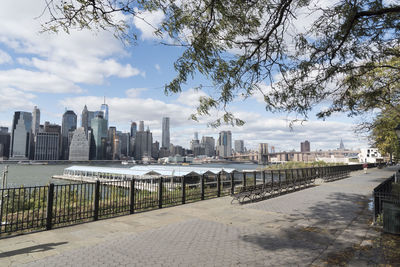 View of cityscape against cloudy sky