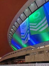 Low angle view of illuminated text on building at night