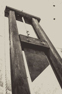 Low angle view of old wooden structure against sky