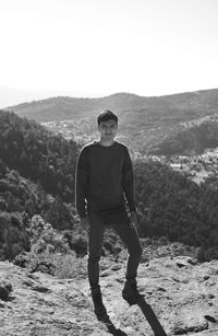 Full length of young man standing on mountain
