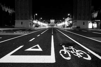 Road sign on street in city at night