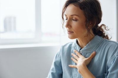 Businesswoman with eyes closed at office