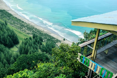 High angle view of trees by sea