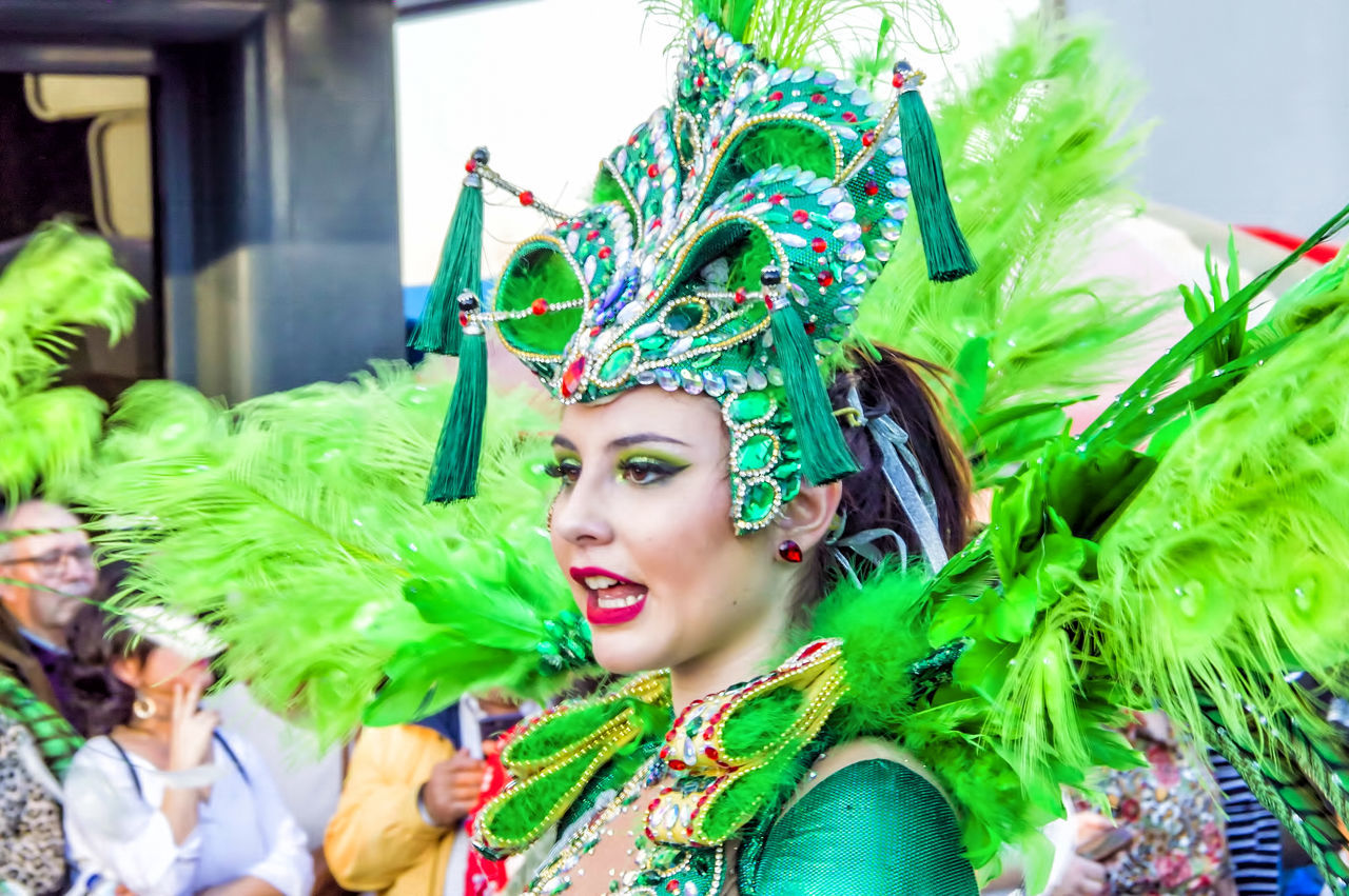 green color, portrait, women, headshot, real people, headwear, adult, costume, young adult, looking away, leisure activity, day, lifestyles, one person, arts culture and entertainment, front view, young women, celebration, looking, headdress, beautiful woman, carnival - celebration event