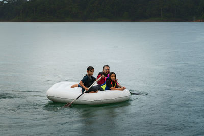 High angel view of family in boat at lake