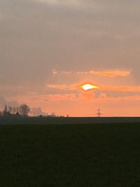 Scenic view of landscape against sky at sunset