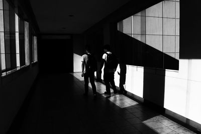 Silhouette people in corridor