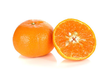 Close-up of orange slices over white background