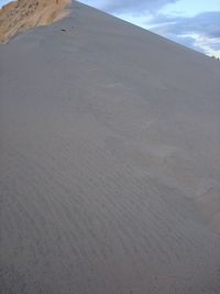 Sand dunes against sky