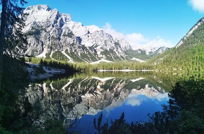 Scenic view of lake and mountains against blue sky