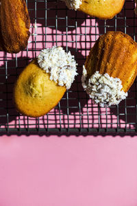 High angle view of madeleines against pink background