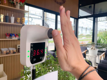 Cropped hand of woman holding navigational compass