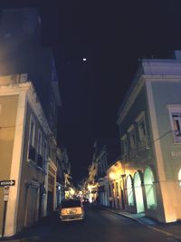 Road along buildings at night