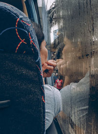 Portrait of woman standing by wall