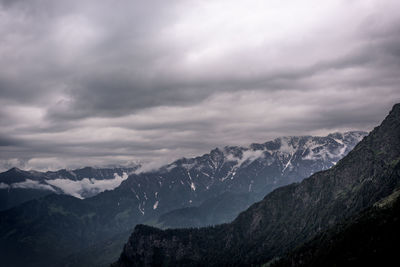 Scenic view of mountains against cloudy sky