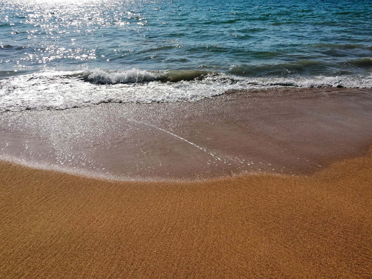 HIGH ANGLE VIEW OF SAND ON BEACH