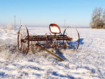 Snow on field against clear sky during winter