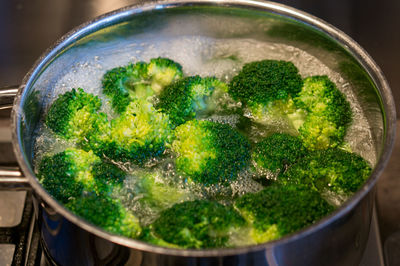 High angle view of broccoli in boiling water on stove