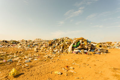 Garbage on sand at beach against sky