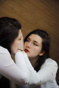 Beautiful young woman reflection