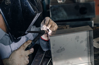 Laser welding process close up. worker in protective clothing welds metal with laser.