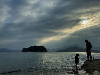 People on beach against sky