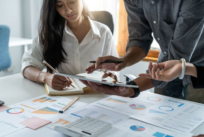 Midsection of business colleagues working at office