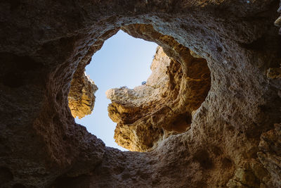 Low angle view of sky seen through rock