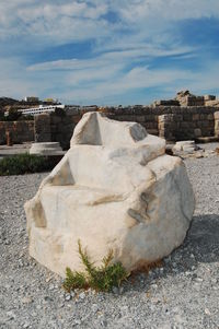 Ancient structure against cloudy sky
