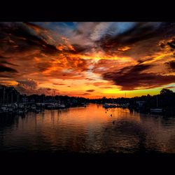 Scenic view of sea against cloudy sky at sunset