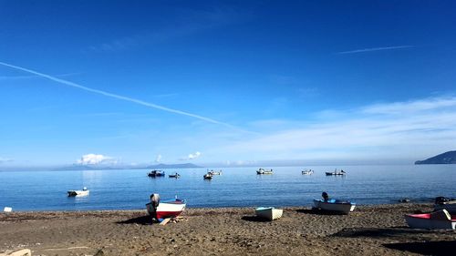 Scenic view of beach against blue sky