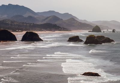 Scenic view of sea and mountains against sky