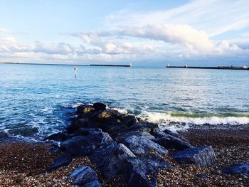 View of calm sea against cloudy sky