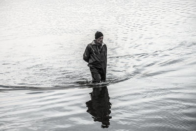 Mature man walking in lake